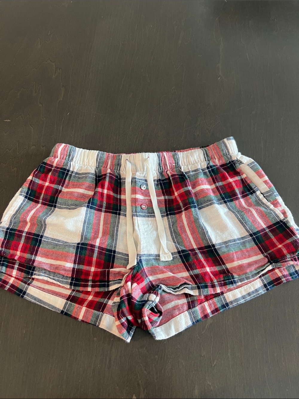 stars above Red, White, and Black Plaid Athletic Shorts